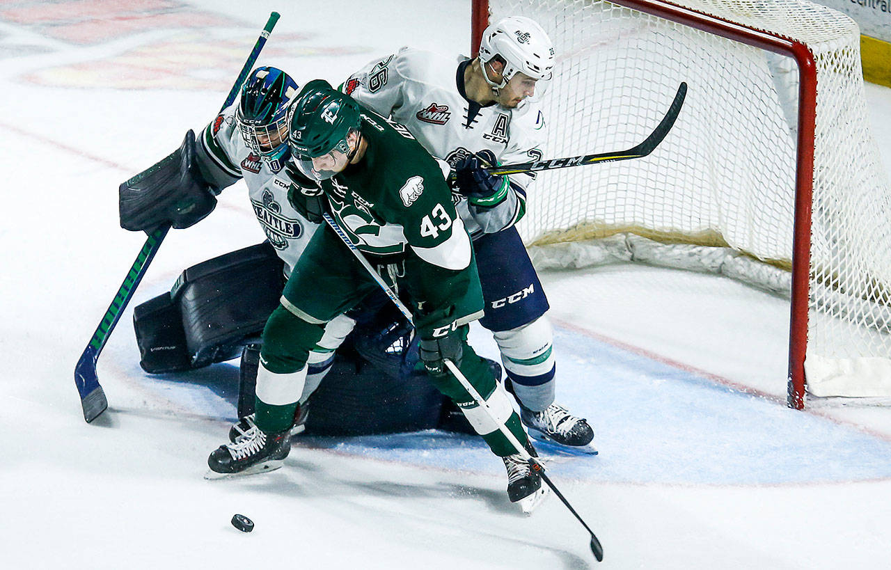 Everett’s Connor Dewar battles for possession of the puck in front of Seattle’s net during a March 27 game in Kent. (Ian Terry / The Herald)