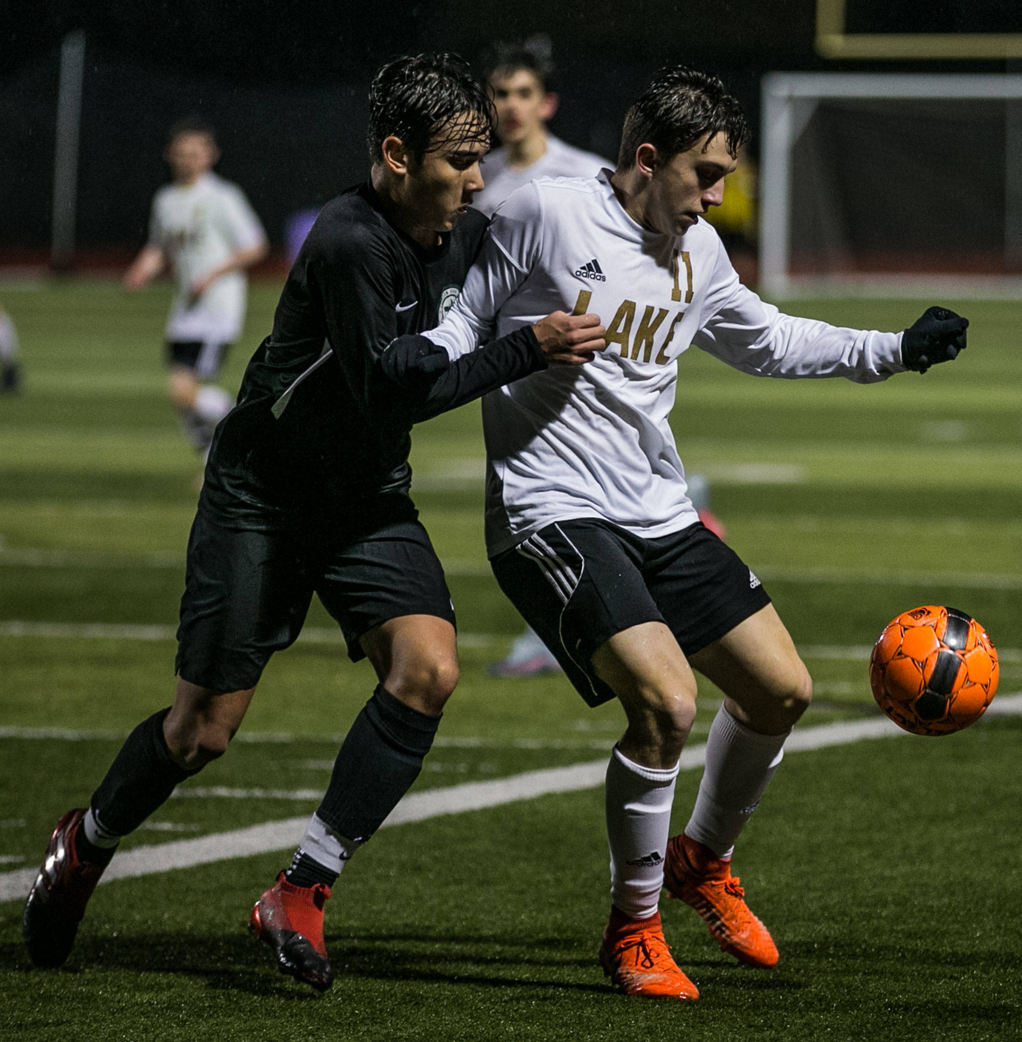 Lake Stevens’ Ethan Anastasi (right) and Jackson’s Oli Giessler compete for control of the ball Wednesday at Lake Stevens High School. (Kevin Clark / The Herald)