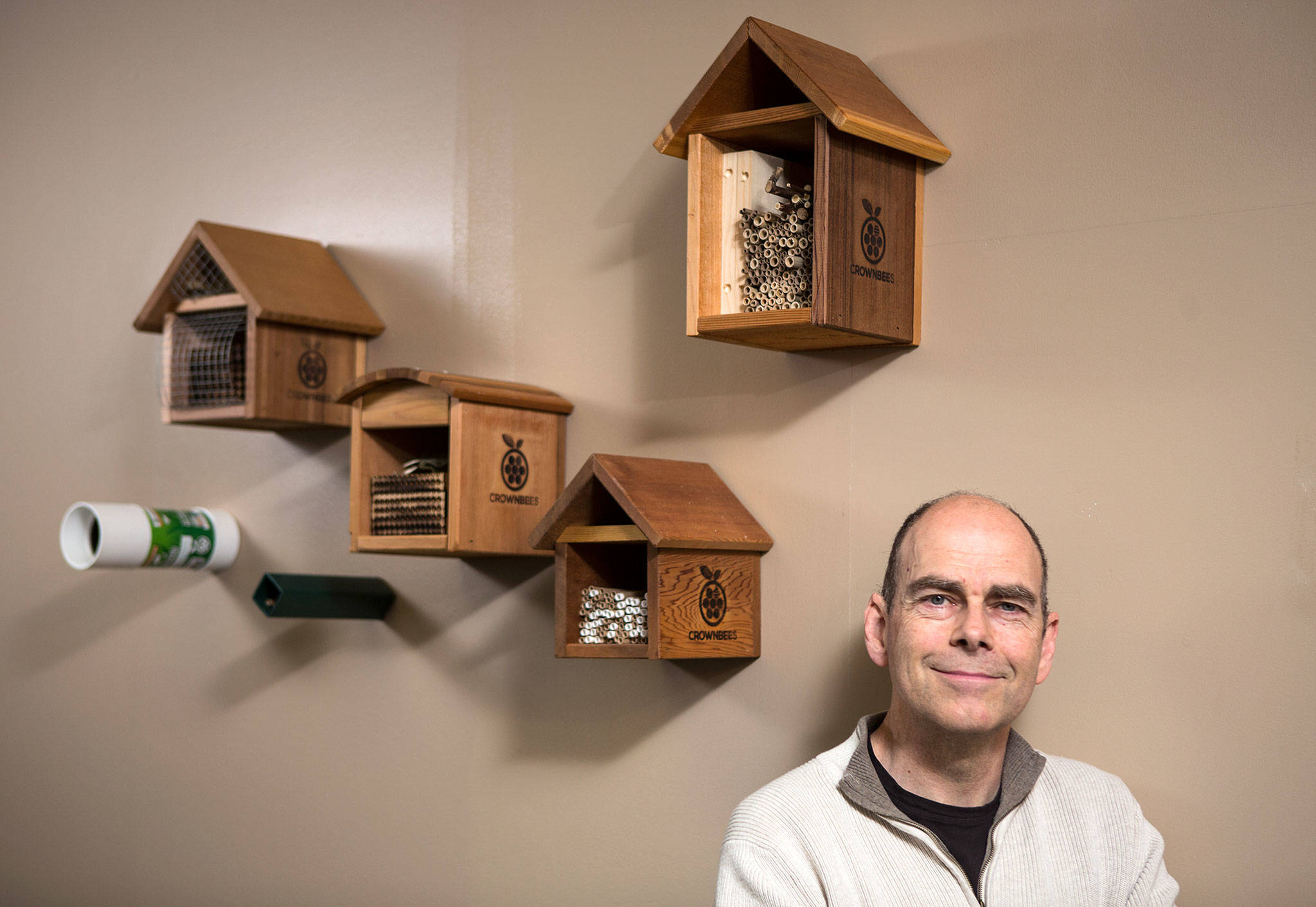 Dave Hunter, founder and owner of Crown Bees, stands by bee nesting houses on Monday, April 9, 2018 in Woodinville. Crown Bees sells mason, leafcutter and other hole-nesting bees for homes, farms and commercial interests. (Andy Bronson / The Herald)