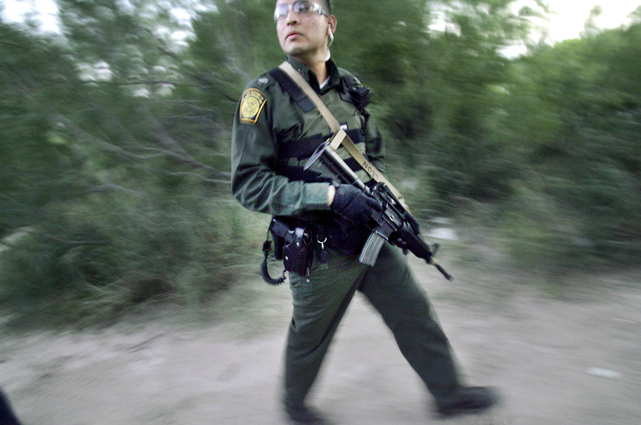In this 2007 photo, U.S. Border Patrol Agent Alberto De Leon checks the banks of the Rio Grande, at the U.S.- Mexico border in Laredo, Texas, an area often used by smugglers. Today, there are more than 20,000 Border Patrol agents along the U.S.-Mexico border and a number of other federal agencies. (AP Photo/LM Otero, File)