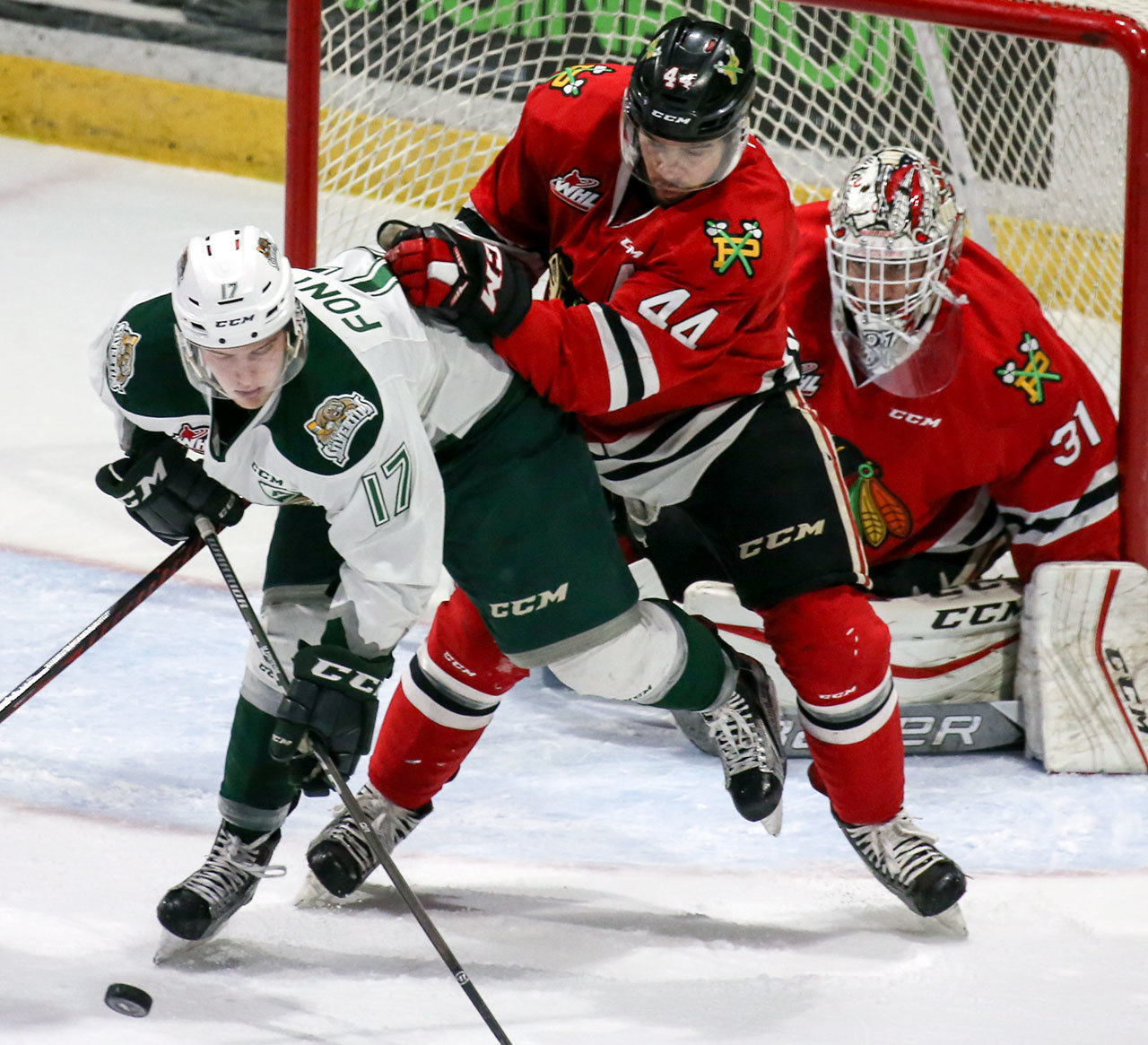 The Silvertips’ Matt Fonteyne (left) controls the puck with the Winterhawks’ Keoni Texeira (middle) and Cole Kehler defending during a game on February 24, 2017, in Everett. (Kevin Clark / The Herald)