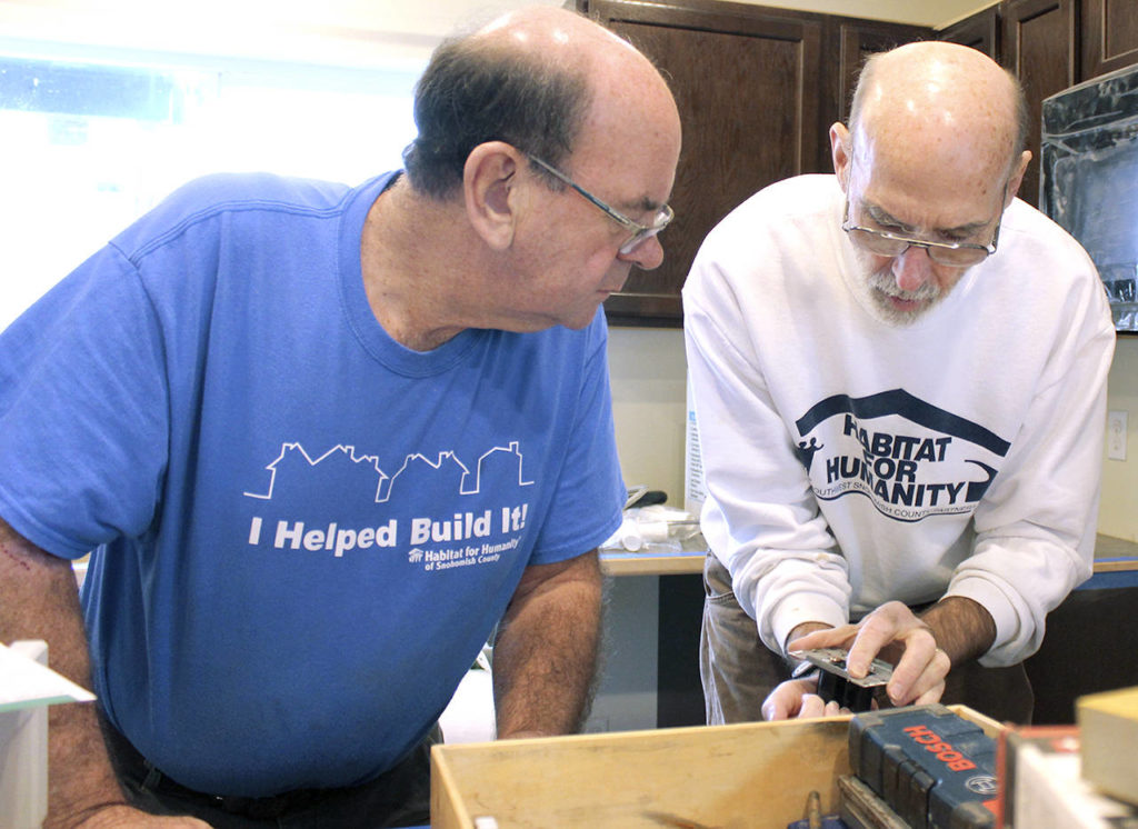 Bill Seufer (left) and Bob Gardner install counters at a Habitat home in Everett. (Habitat for Humanity of Snohomish County)
