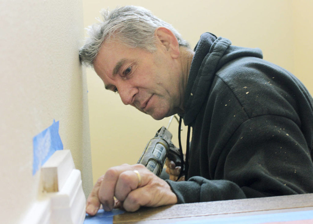 Jan Kallishan installs stair moulding for a Habitat home in Everett. (Habitat for Humanity of Snohomish County)
