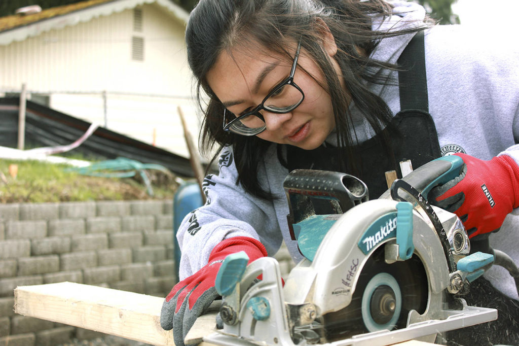 Stephanie Lam, with AmeriCorps, does framing at the Twin Creeks Village construction site. (Habitat for Humanity of Snohomish County)
