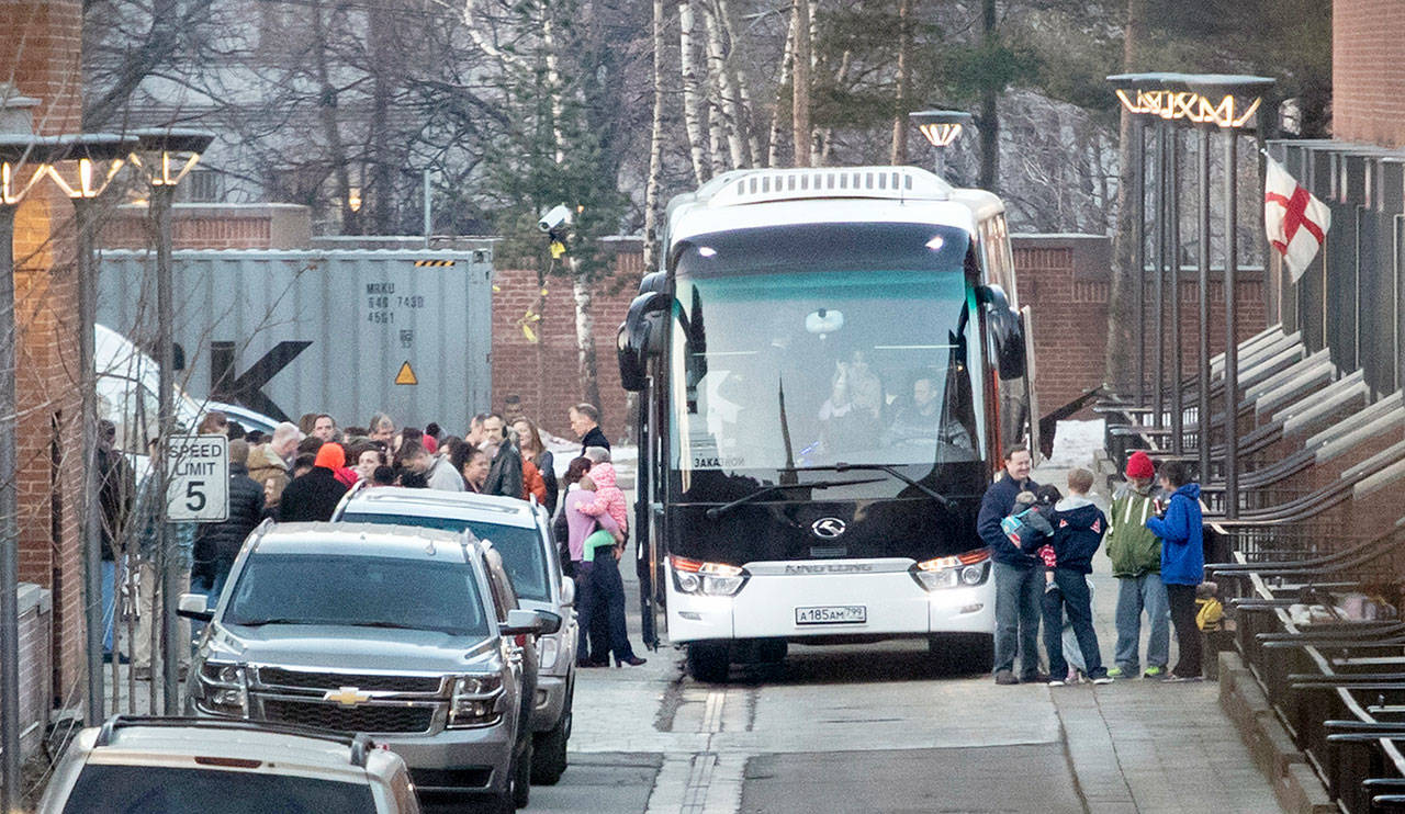 Buses wait to carry expelled diplomats and their families from the U.S. Embassy in Moscow, Russia, on Thursday. (AP Photo/Pavel Golovkin)