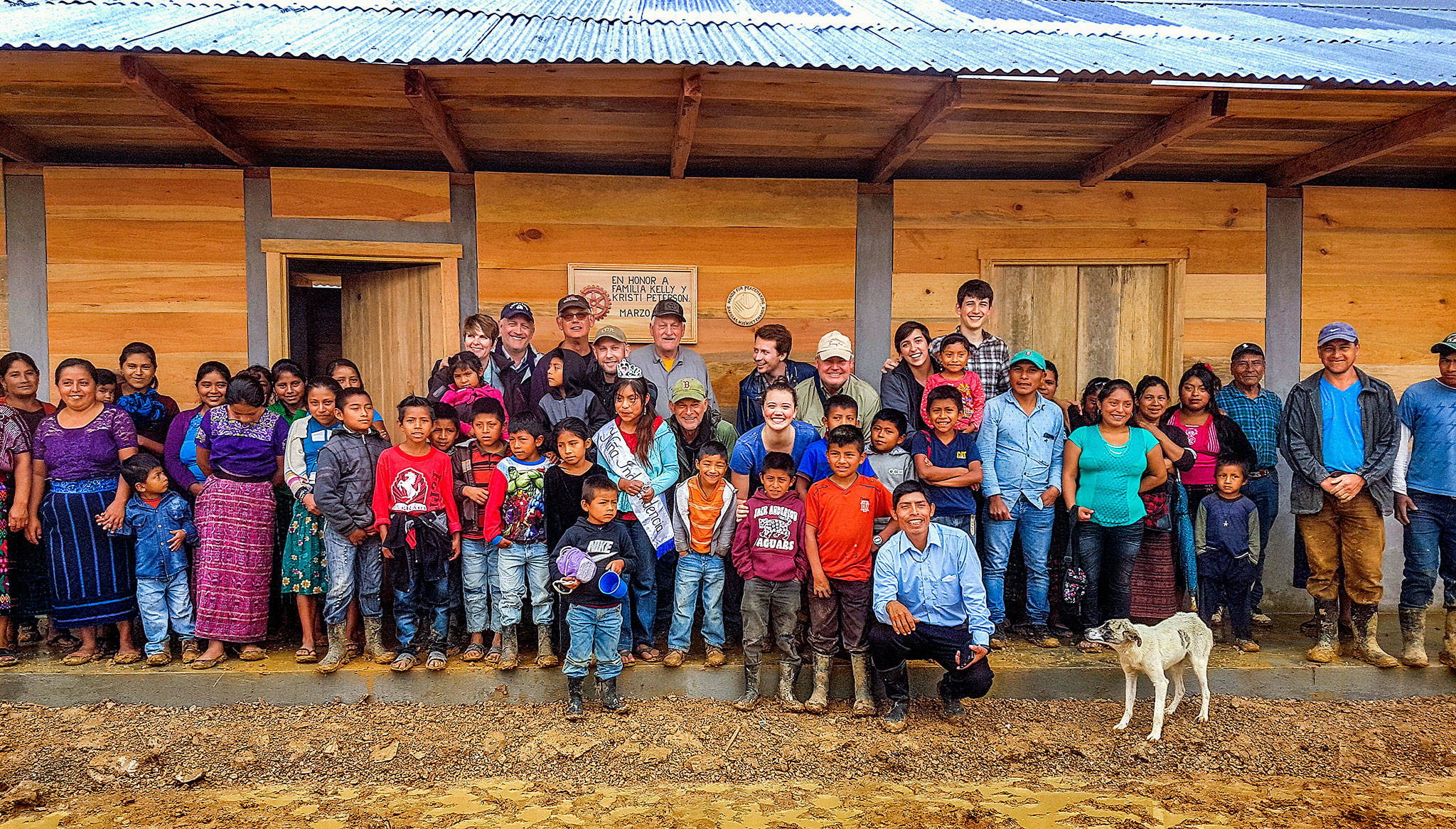 Guatemalan villagers join with volunteers from the Hands for Peacemaking Foundation outside the school the Everett-based nonprofit helped build last month in the village of Canton Maya Jaguar. (Larry Jubie photo)