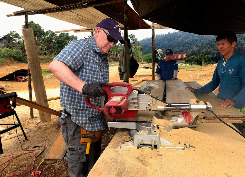 Dr. Kelly Peterson, a Marysville dentist, operates a saw in the Guatemalan village of Canton Maya Jaguar last month. With a group from the Everett-based Hands for Peacemaking Foundation, Peterson helped build a school for the village that was dedicated in his honor. (Larry Jubie photo)
