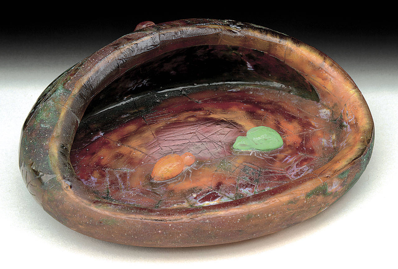 No, it is not a bowl that was overheated and melted. It is a “vide poche,” a French dresser storage dish, a vintage form that is no longer popular. It was made by Daum, a famous French glass company that is now called Cristalleries de Nancy. (Cowles Syndicate Inc.)