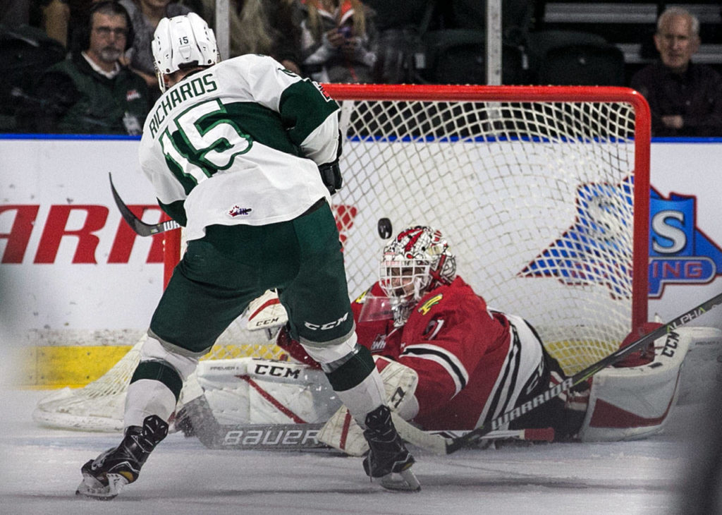 The Silvertips’ Sean Richards (15) scores past Winterhawks goalie Cole Kehler during a playoff game on April 6, 2018, at Angel of the Winds Arena in Everett. (Kevin Clark / The Herald)
