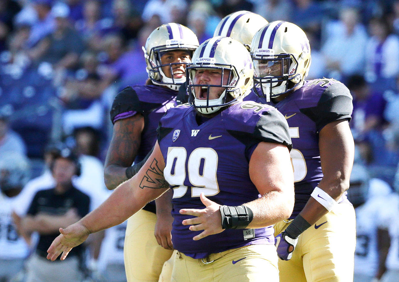 Washington defensive lineman Greg Gaines (99) celebrates a sack against Idaho in the first half of a game Sept. 10, 2016, in Seattle. (AP Photo/Ted S. Warren)