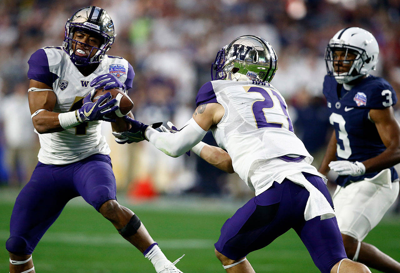 Washington’s Austin Joyner (4) intercepts a pass intended for Penn State wide receiver DeAndre Thompkins (3) as Washington’s Taylor Rapp (21) moves in during the second half of the 2017 Fiesta Bowl on Dec. 30 in Glendale, Ariz. Joyner, a former Marysville Pilchuck player, missed the second week of the Huskies’ spring practices with an undisclosed injury. (AP Photo/Ross D. Franklin)