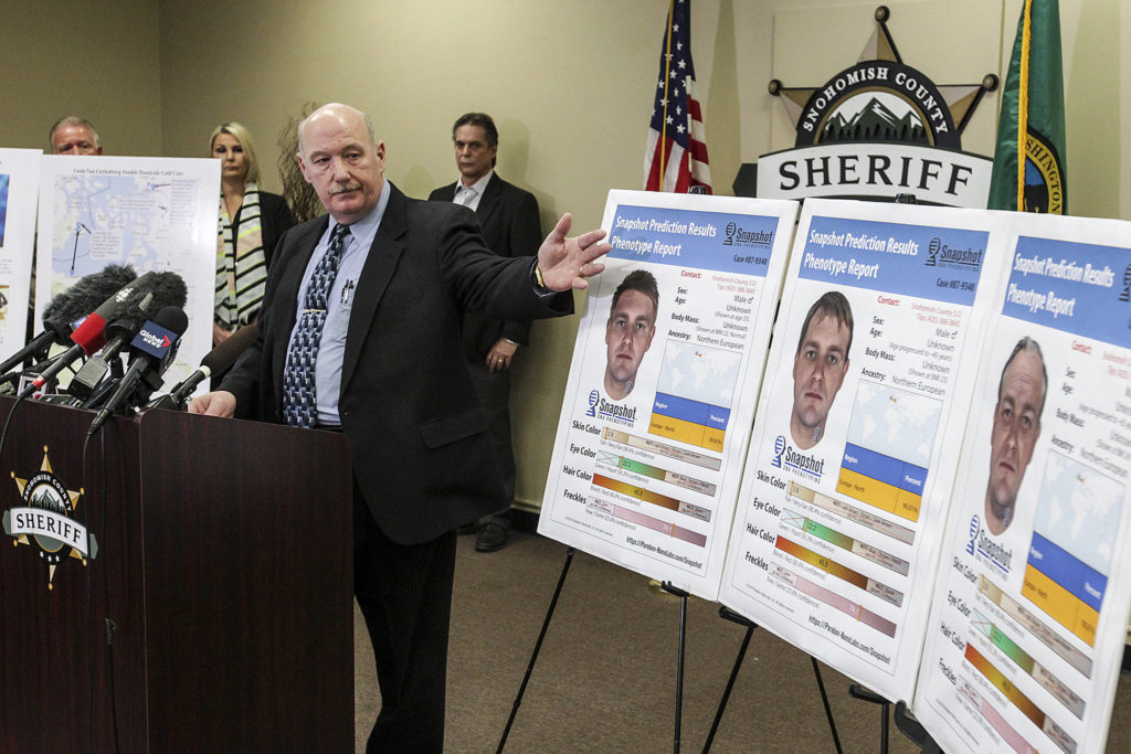 Snohomish County cold case detective Jim Scharf (left) presents new images of a potential suspect in the unsolved 1987 murder of Jay Cook and Tanya Van Cuylenborg during a news conference in Everett on Wednesday. (Ian Terry / The Herald)
