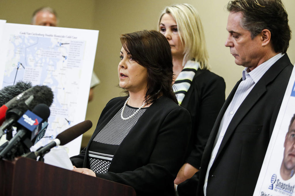 Laura Baanstra (center), a sister of 1987 homicide victim Jay Cook, speaks at a news conference in Everett on Wednesday. (Ian Terry / The Herald)
