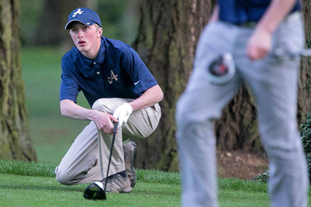 Arlington’s Cody Oakes watches his tee shot during the playoff at the Tom Dolan Memorial Invitational at Everett Golf and Country Club Monday afternoon. (Kevin Clark / The Herald)
