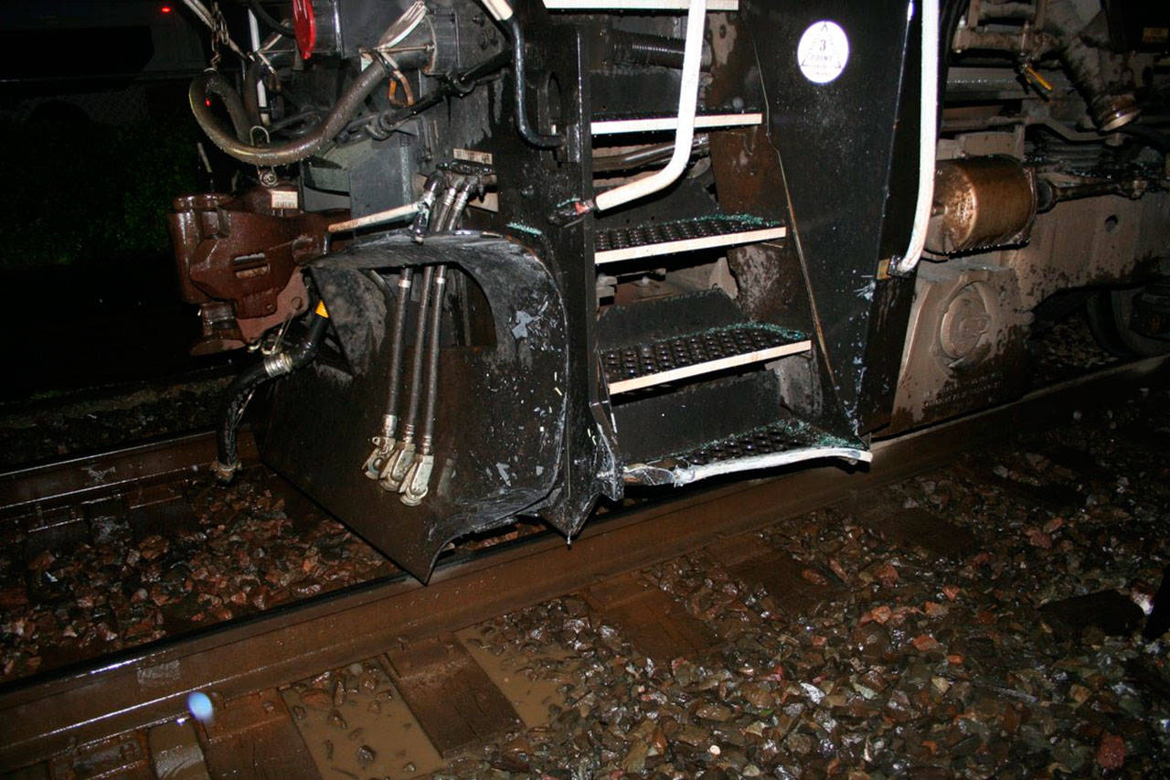 A train hit a car Wednesday night after it got stuck on the tracks in Edmonds. Minor injuries were reported. (Edmonds Police Department)