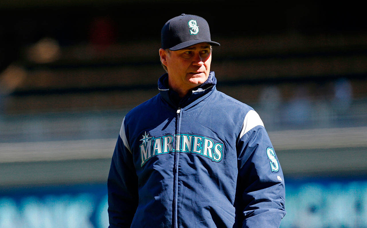 Mariners manager Scott Servais returns to the dugout after a pitching change against the Twins during a game April 7, 2018, in Minneapolis. (AP Photo/Jim Mone)