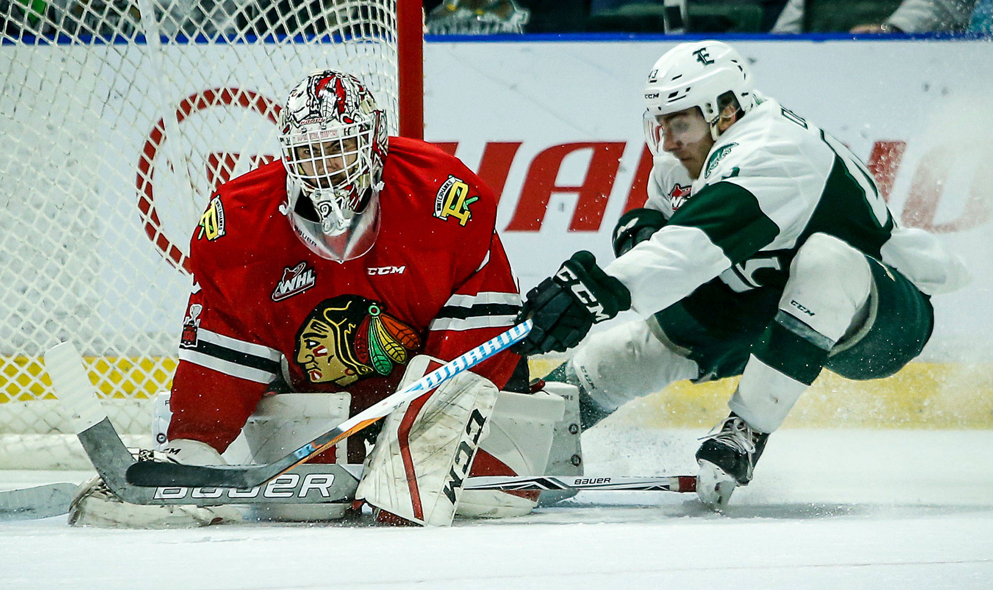 Silvertips center Connor Dewar (right) pressures Portland goaltender Cole Kehler during a playoff game on April 7, 2018, at Angel of the Winds Arena in Everett. (Ian Terry / The Herald)