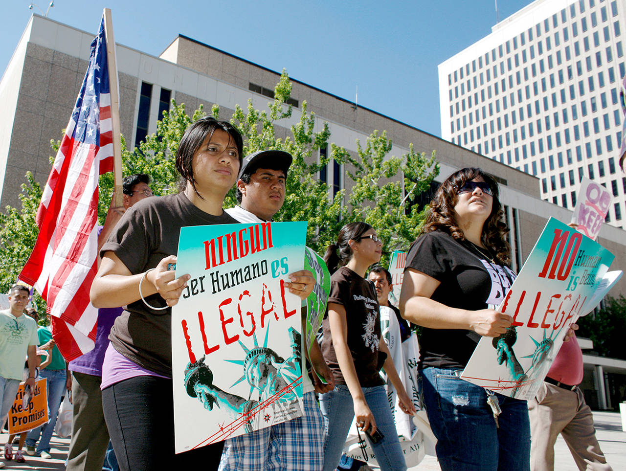 In this 2010 photo, immigration reform advocates march around the Federal Courthouse in downtown Denver. (AP Photo/David Zalubowski, File)