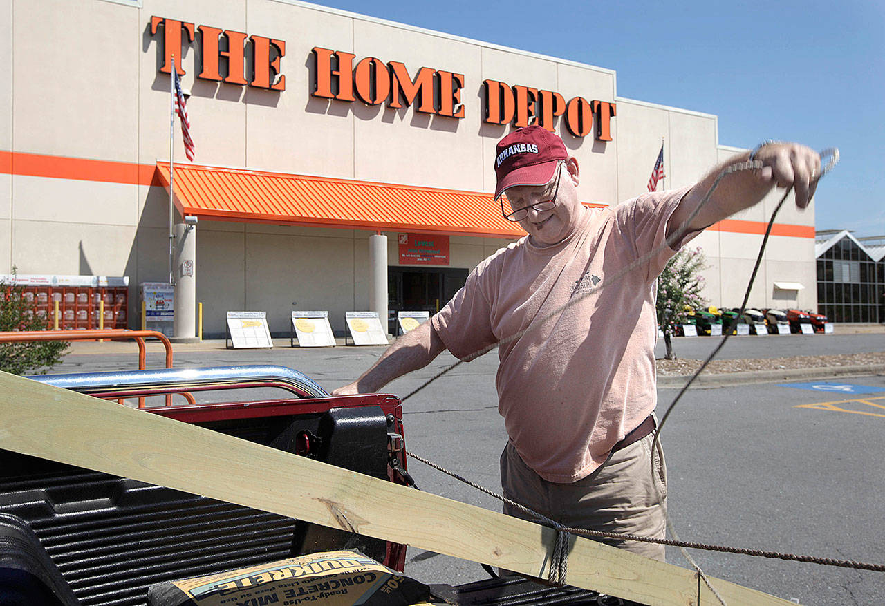 A customer lashes building materials down to his truck at a Home Depot store in North Little Rock, Arkansas. (AP Photo/Danny Johnston)