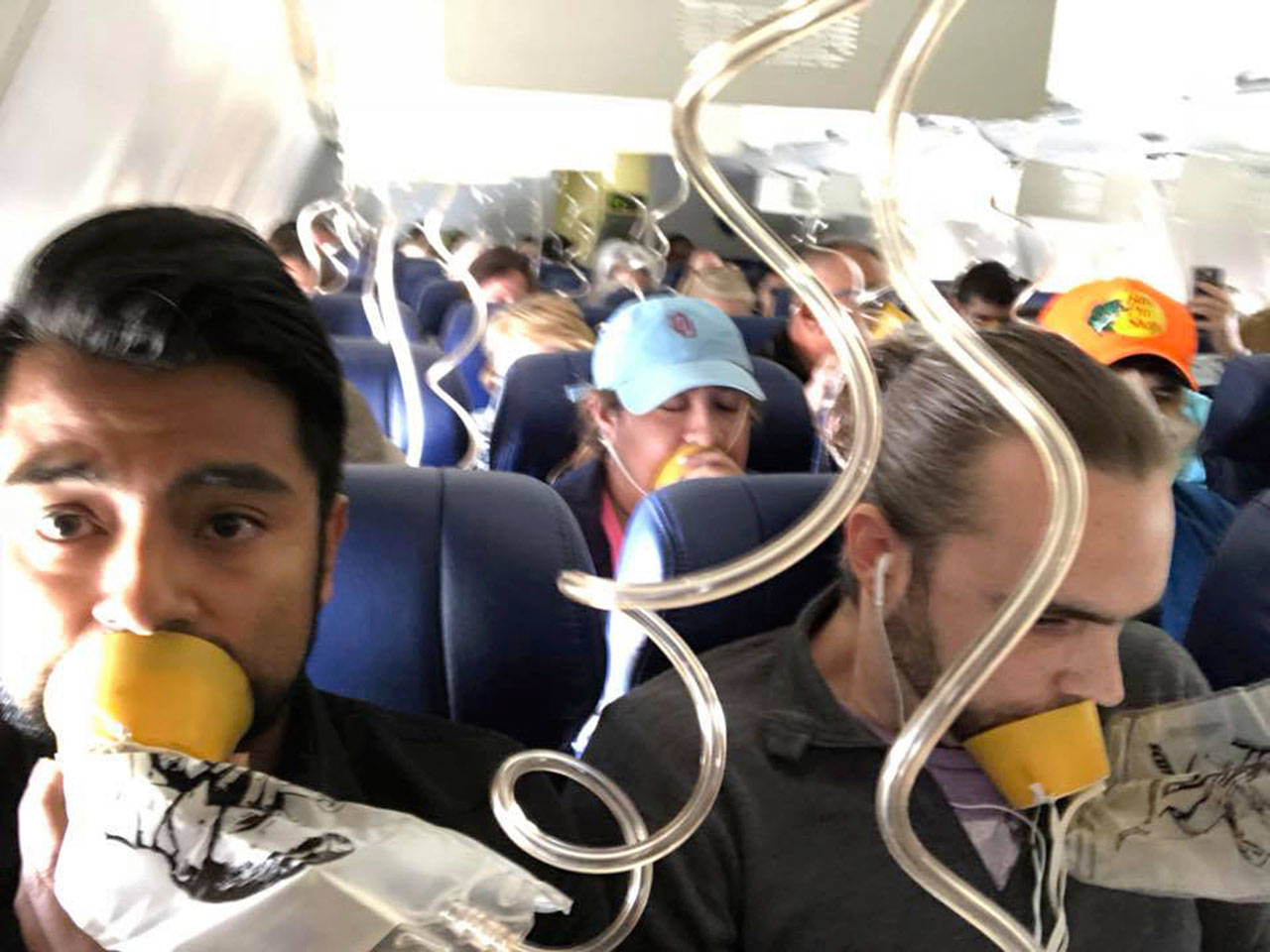 Marty Martinez (left) appears with other passengers after a jet engine blew out on a Southwest Airlines Boeing 737, resulting in the death of a woman who was nearly sucked from a window during the flight. (Marty Martinez via AP)
