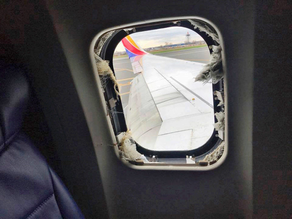The window that was shattered after a jet engine ona Southwest Airlines airplane blew out. (Marty Martinez via AP) 
