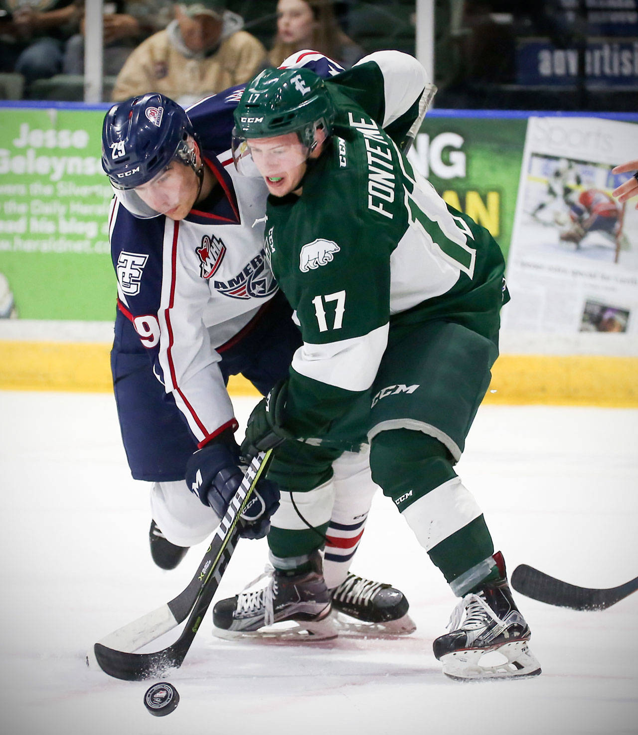 The Silvertips’ Matt Fonteyne and the Americans’ Brett Leason battle during a face-off on Oct. 18, 2017, in Everett. (Kevin Clark / The Herald)