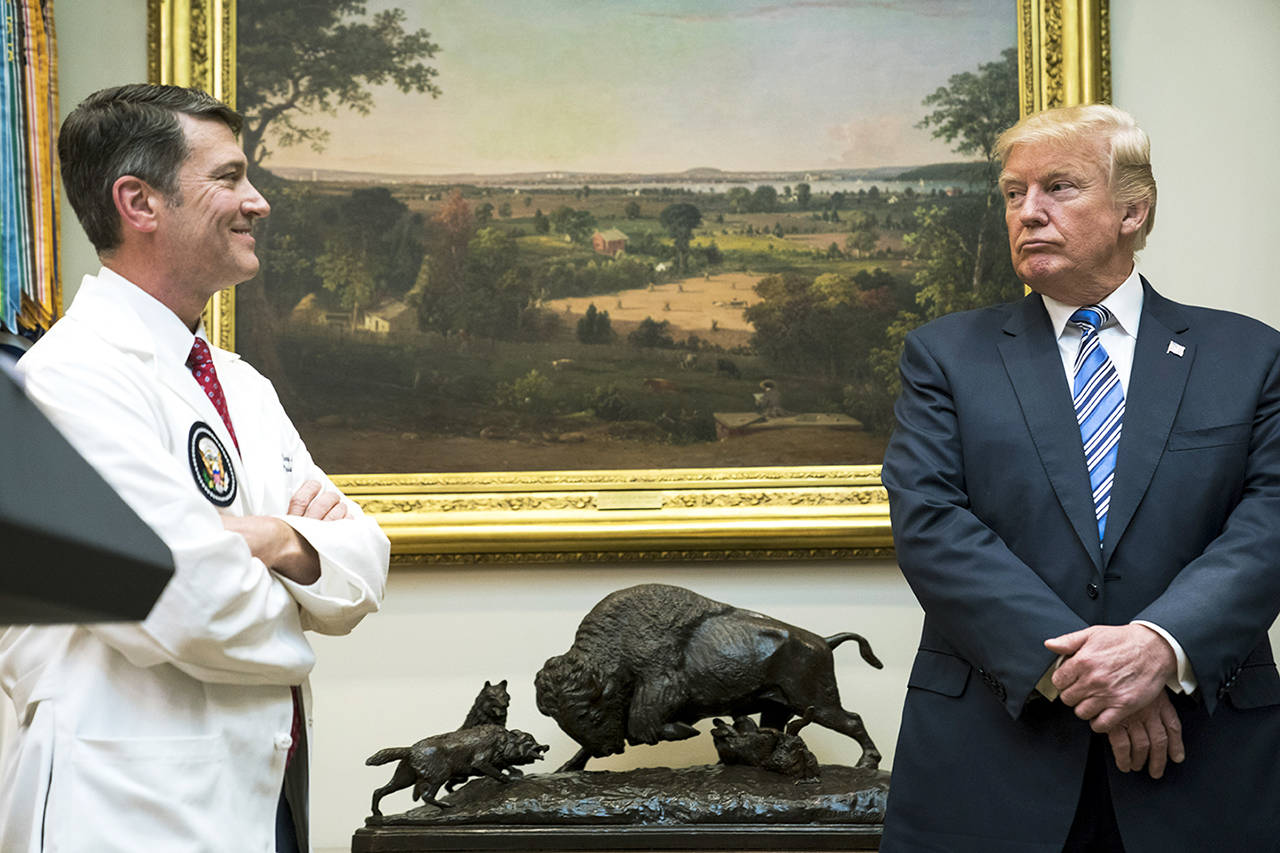 President Donald Trump looks to White House physician Ronny Jackson during a Veterans Affairs Department “telehealth” event in the Roosevelt Room of the White House in Washington in 2017. (Jabin Botsford/Bloomberg, file)