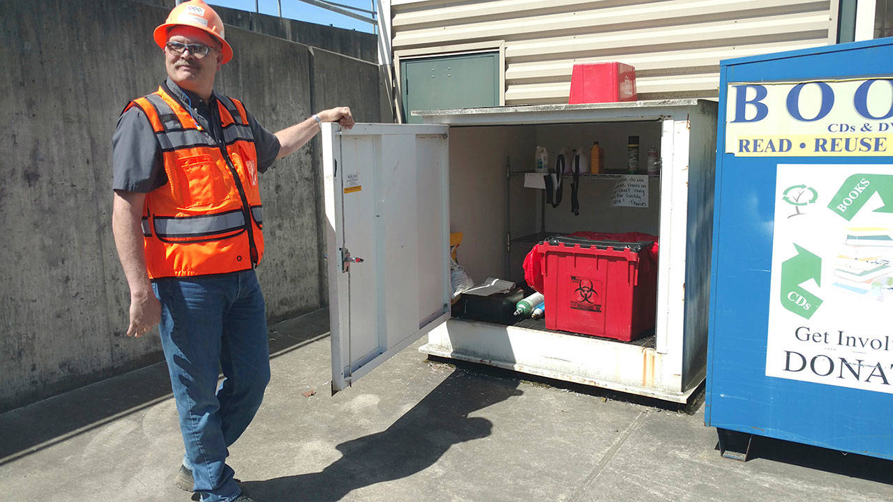 Snohomish County Solid Waste Operations Manager Dave Schonhard shows the new disposal site for sealed sharps containers, which are included in free needle clean-up kits, at the recycling and transfer station off Airport Road. (Kari Bray / The Herald)