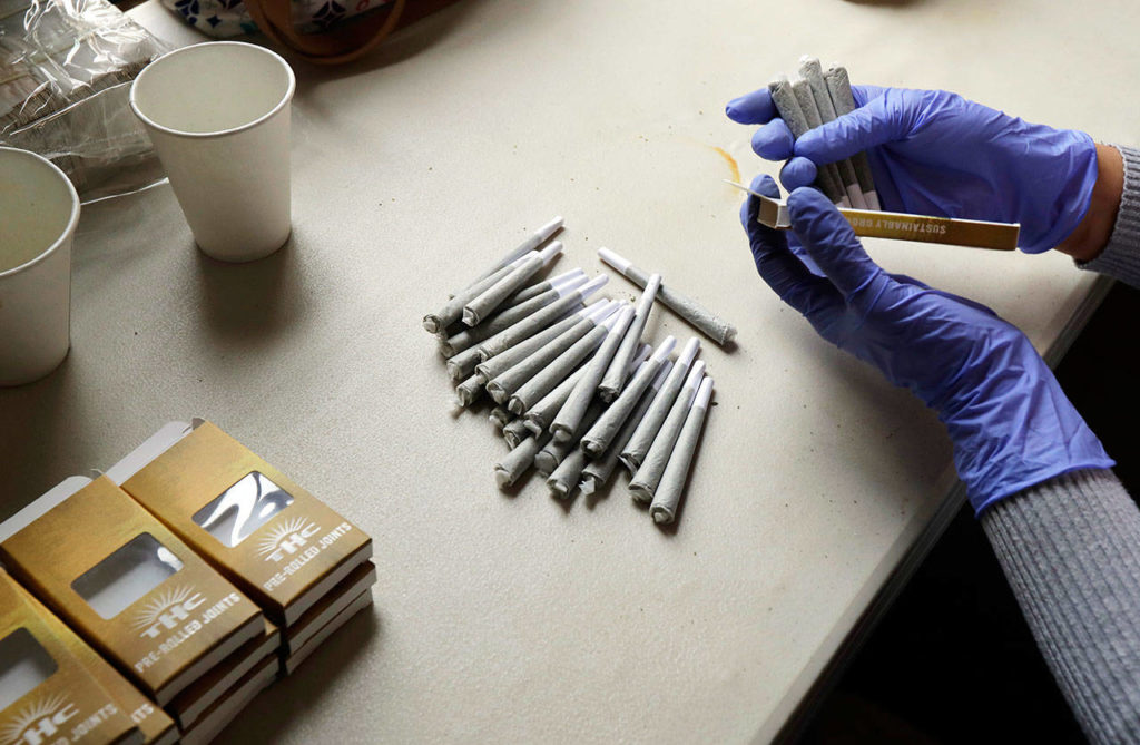 A worker at the Hollingsworth Cannabis Company packages pre-rolled marijuana joints near Shelton, Washington, on April 12. (AP Photo/Ted S. Warren)
