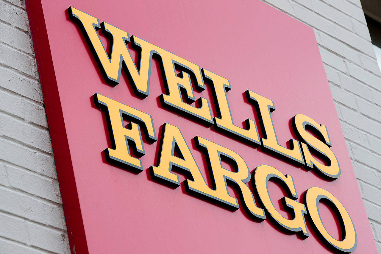 Wells Fargo will pay $1 billion to federal regulators to settle charges tied to its mortgage and auto lending business. (AP Photo/Matt Rourke, File)