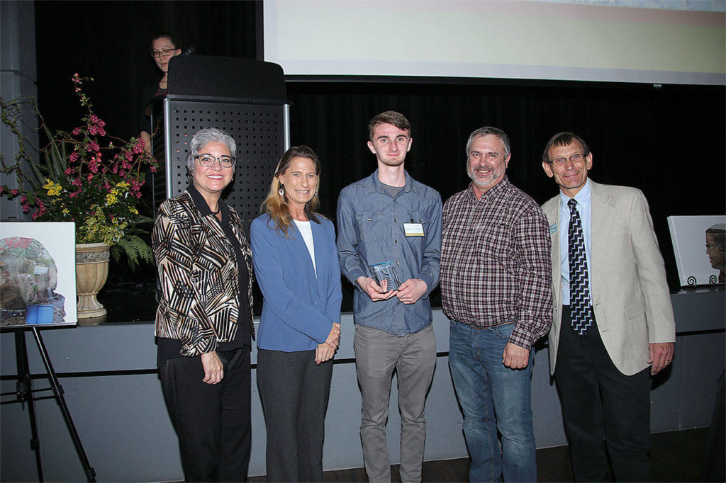 Jarrett Delfel (center) receives a Youth Conservation Leader of the Year award. He’s pictured with, from left, Maia Bellon, Washington Department of Ecology director, Stephanie Wright, Snohomish County Council chair, Mark Craven, Snohomish Conservation District Board chair, and Monte Marti, SCD district manager. (Contributed photo)
