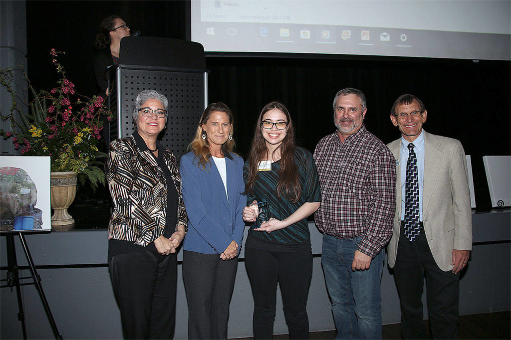 Emily McLaughlin Sta. Maria (center) receives a Youth Conservation Leader of the Year award. He’s pictured with, from left, Maia Bellon, Washington Department of Ecology director, Stephanie Wright, Snohomish County Council chair, Mark Craven, Snohomish Conservation District Board chair, and Monte Marti, SCD district manager. (Contributed photo)
