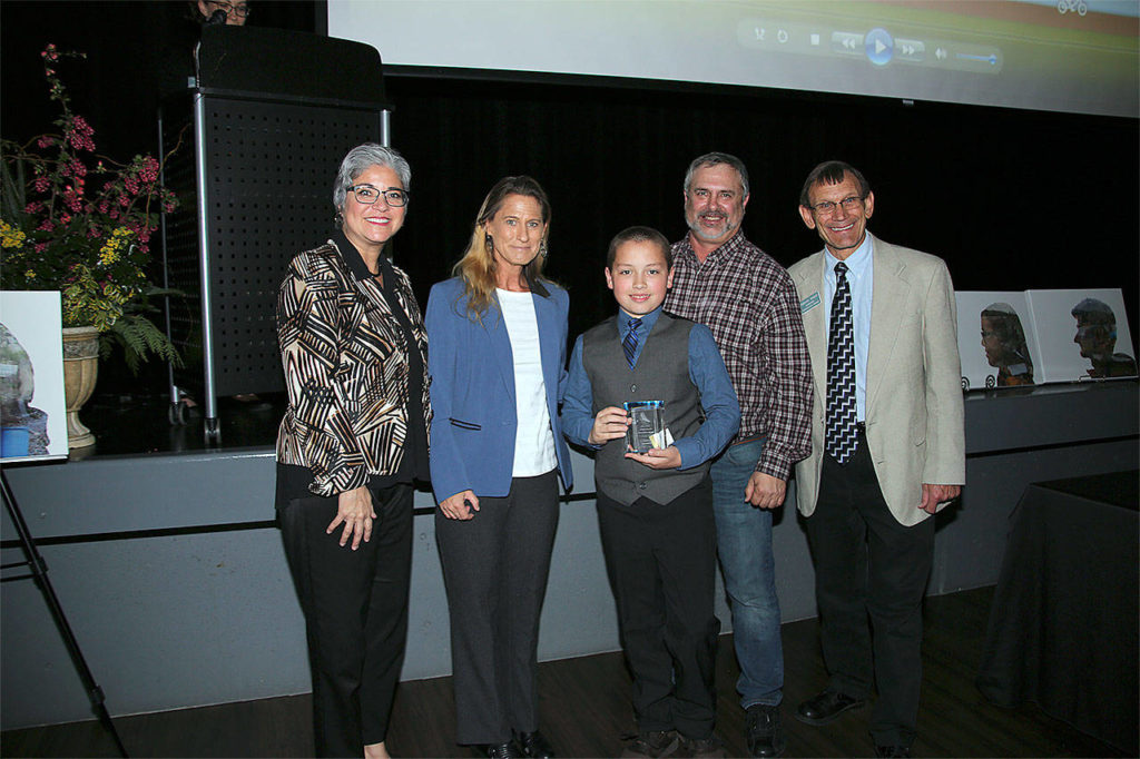 James Osborn (center) receives a Youth Conservation Leader of the Year award. He’s pictured with, from left, Maia Bellon, Washington Department of Ecology director, Stephanie Wright, Snohomish County Council chair, Mark Craven, Snohomish Conservation District Board chair, and Monte Marti, SCD district manager. (Contributed photo)
