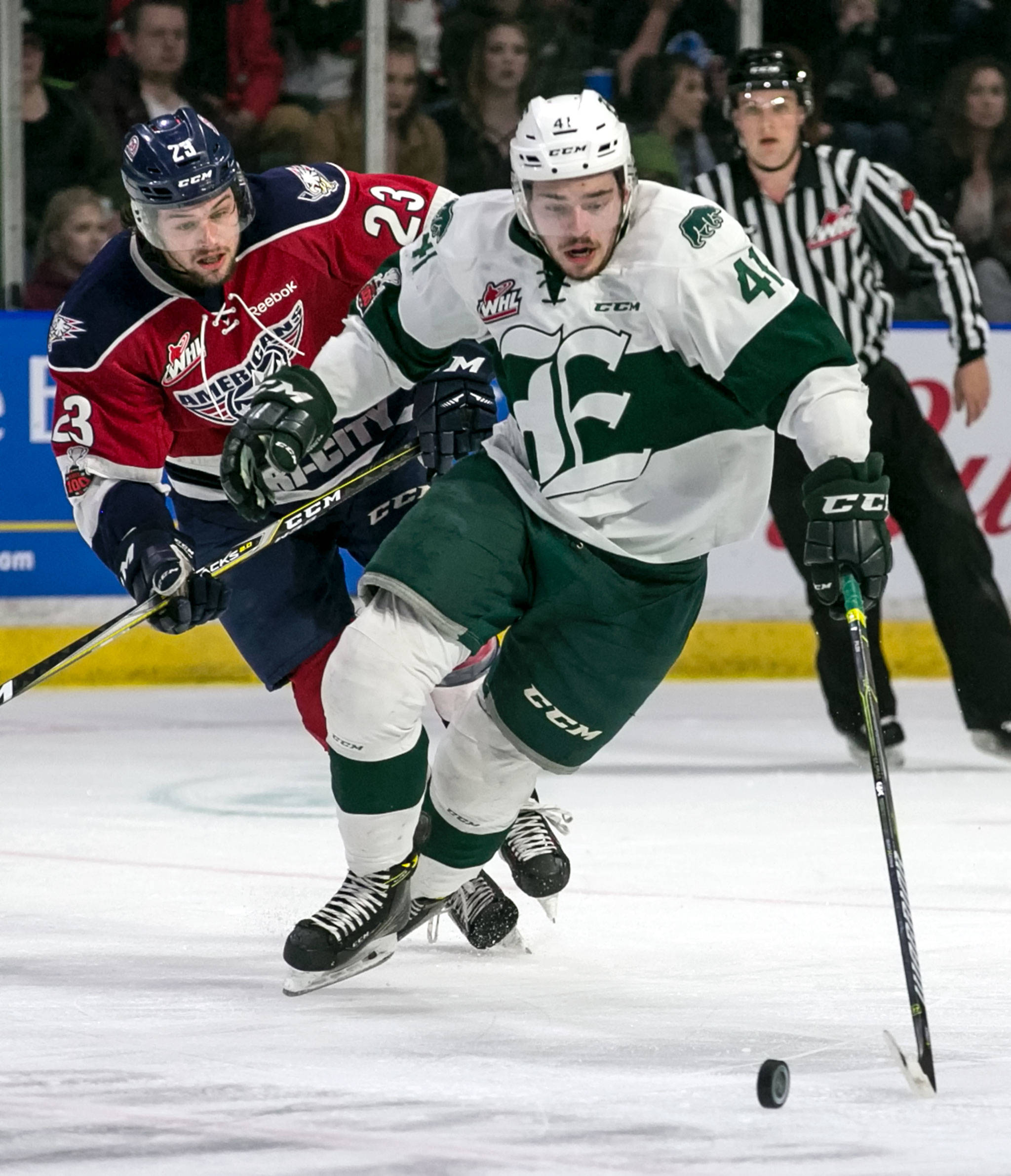 The Silvertips’ Garrett Pilon chases down the puck with the Americans’ Isaac Johnson trailing during Game 1 of the Westernce Conference finals on April 20, 2018, at Angel of the Winds Arena in Everett. (Kevin Clark / The Herald)