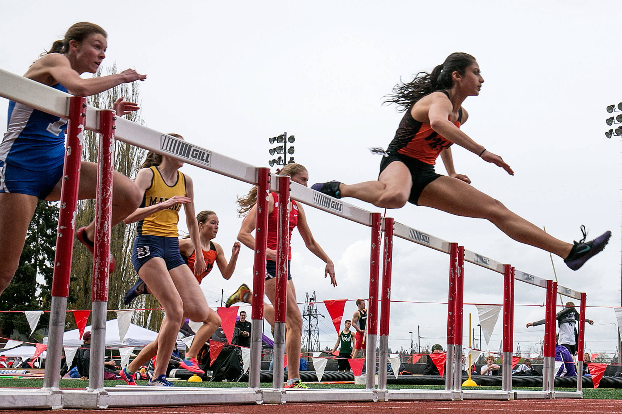 Monroe’s Hannah Ganashamoorthy leads the pack in the 100-meter hurdles during the annual Larry Eason Invitational on April 21, 2018, at Veterans Memorial Stadium in Snohomish. (Kevin Clark / The Herald)