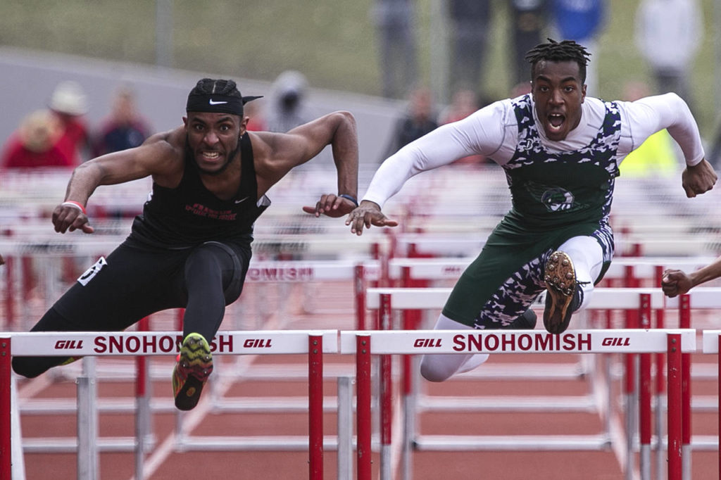 Franklin Pierce’s Tyrell Edge (left) beats Edmonds-Woodway’s Aaron Richardson by .04 seconds in the 110-meter hurdles during the annual Larry Eason Invitational on April 21, 2018, at Veterans Memorial Stadium in Snohomish. (Kevin Clark / The Herald)
