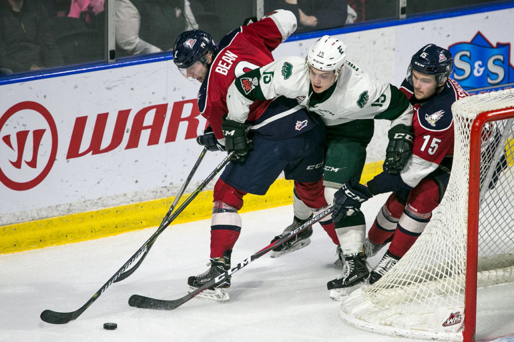 The Silvertips’ Sean Richards attempts to splits Tri-City’s Jake Bean (left) and Tri-City’s Michael Rasmussen during a playoff game on April 21, 2018, at Angel of the Winds Arena in Everett. (Kevin Clark / The Herald)
