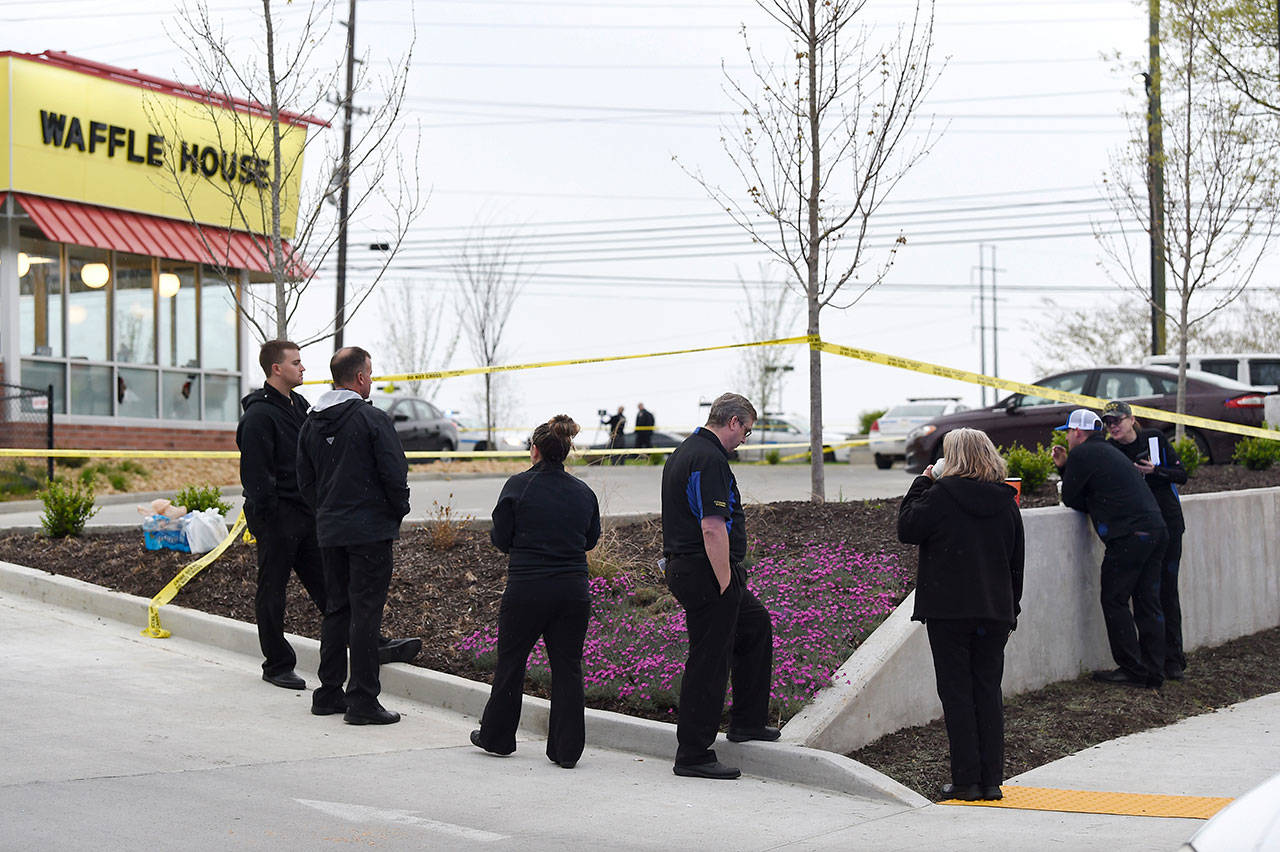 Law enforcement officials work the scene of a fatal shooting at a Waffle House in the Antioch neighborhood of Nashville, on Sunday. (George Walker IV/The Tennessean via AP)