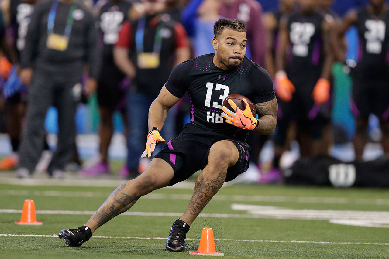 LSU running back Derrius Guice runs a drill at the NFL football scouting combine in Indianapolis, Friday, March 2, 2018. (Michael Conroy / Associated Press)