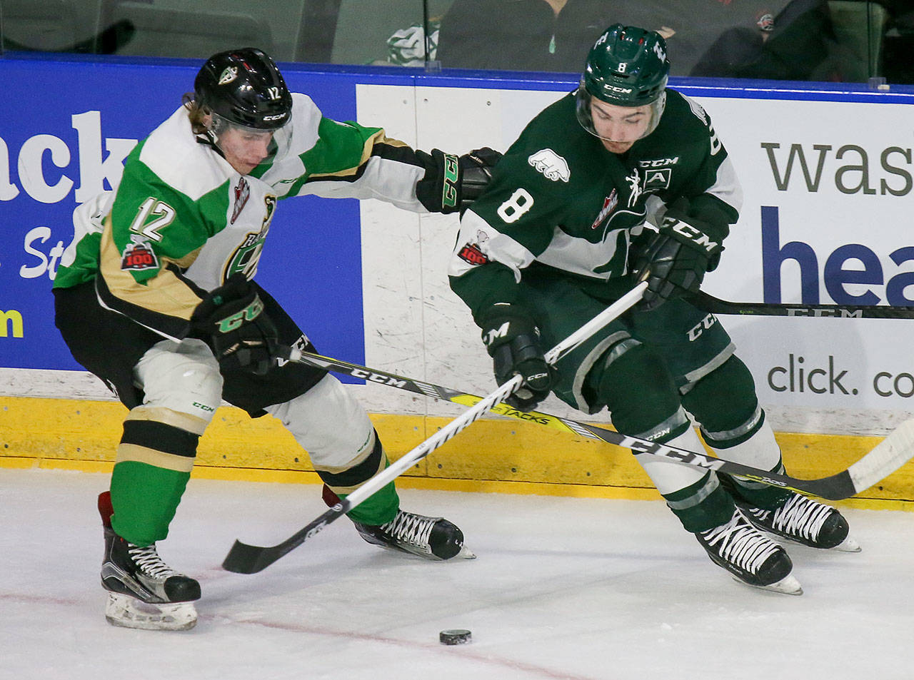 The Silvertips’ Patrick Bajkov (right) and Prince Albert’s Sergei Sapego battle for control of the puck during a game on Nov. 15, 2017, in Everett. (Kevin Clark / The Herald)