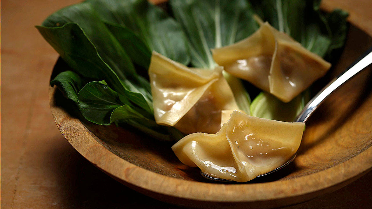 Ground pork, ginger, green onion, sesame oil and other flavorings bolster the broth tucked into dumplings made from wonton wrappers. (E. Jason Wambsgans/Chicago Tribune)