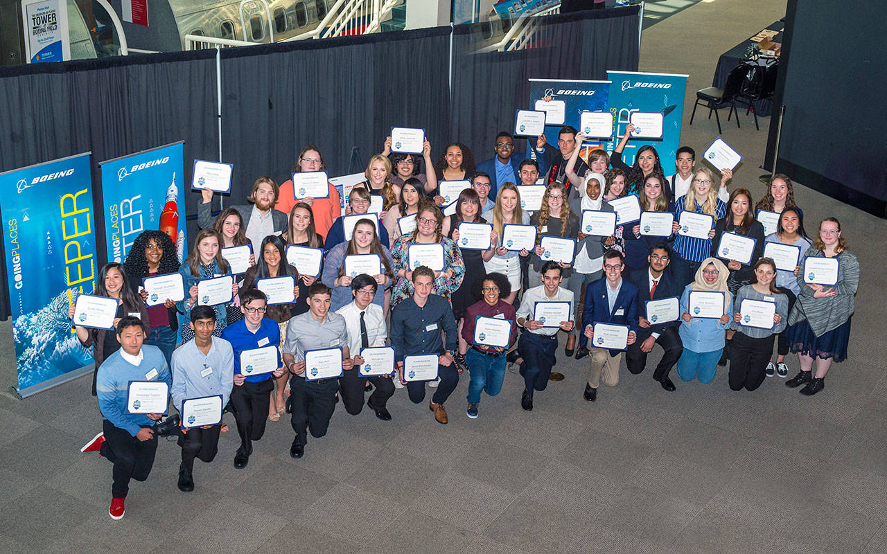 High school students from across Washington state hold up their letters of intent to pursue science, technology, engineering and mathematics fields in college during asigning day event put on by Washington STEM on Tuesday. (The Boeing Company)