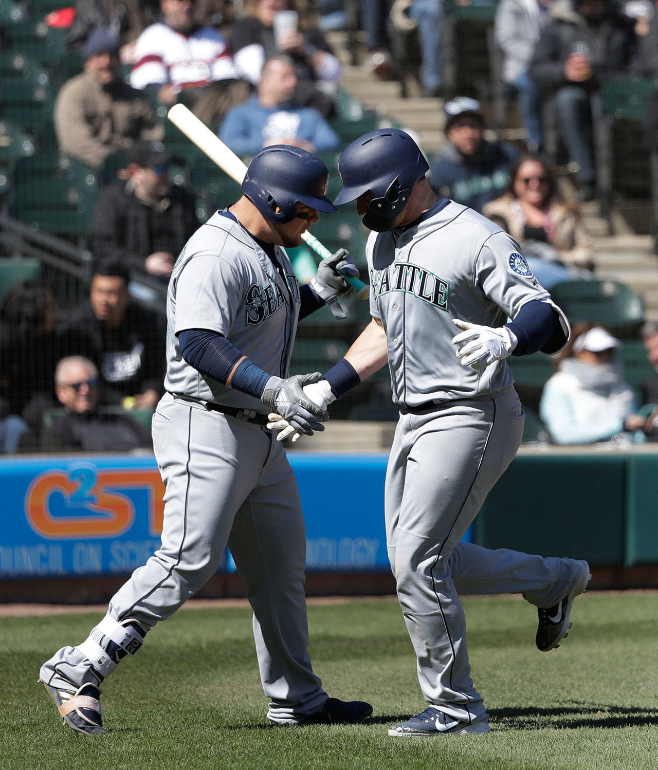 Seattle’s Mike Zunino (right) greets teammate Daniel Vogelbach at home plate after Zunino hit a home run during the sixth inning of Wednesday’s game in Chicago. (AP Photo/Charles Rex Arbogast)