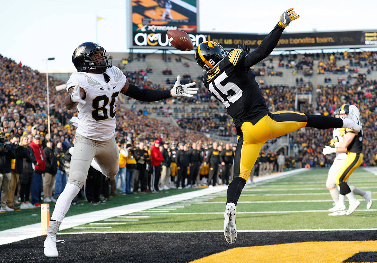Iowa defensive back Josh Jackson (15) breaks up a pass intended for Purdue wide receiver Jarrett Burgess (80) during the first half of a game Nov. 18, 2017, in Iowa City, Iowa. (AP Photo/Charlie Neibergall)