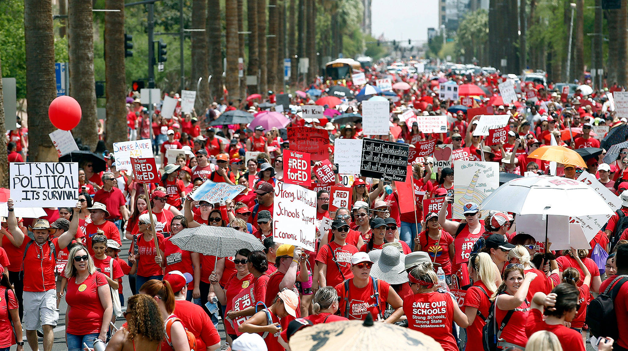 Thousands march to the Arizona Capitol to advocate for higher teacher pay and school funding on Thursday in Phoenix. (AP Photo/Ross D. Franklin)