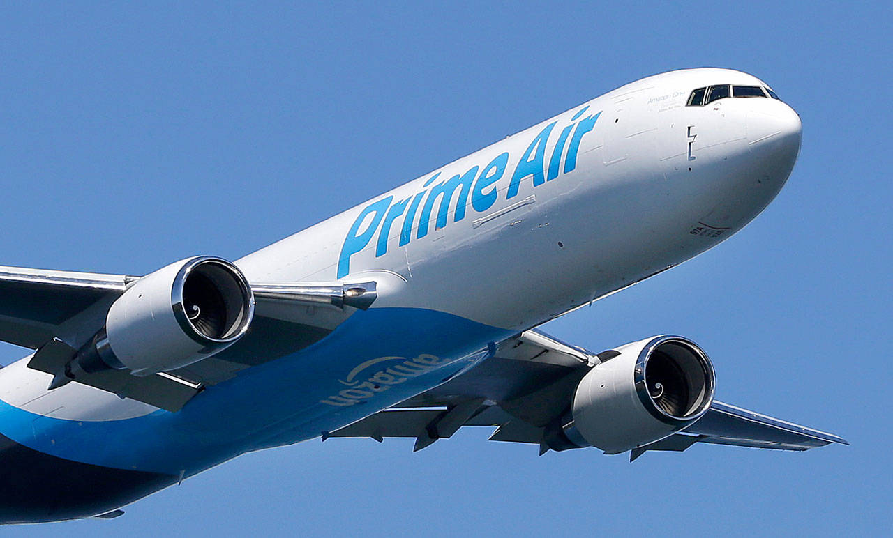 A Boeing 767 freighter with an Amazon.com “Prime Air” livery flies over Lake Washington in 2016 as part of the Boeing Seafair Air Show. (AP Photo/Ted Warren)