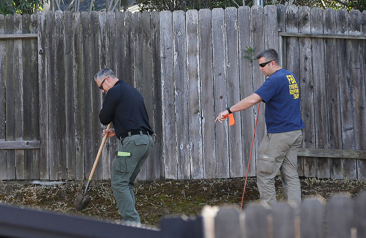 Authorities probe the backyard of the home of murder suspect Joseph DeAngelo on Thursday in Citrus Heights, Calif. (Rich Pedroncelli / AP Photo)