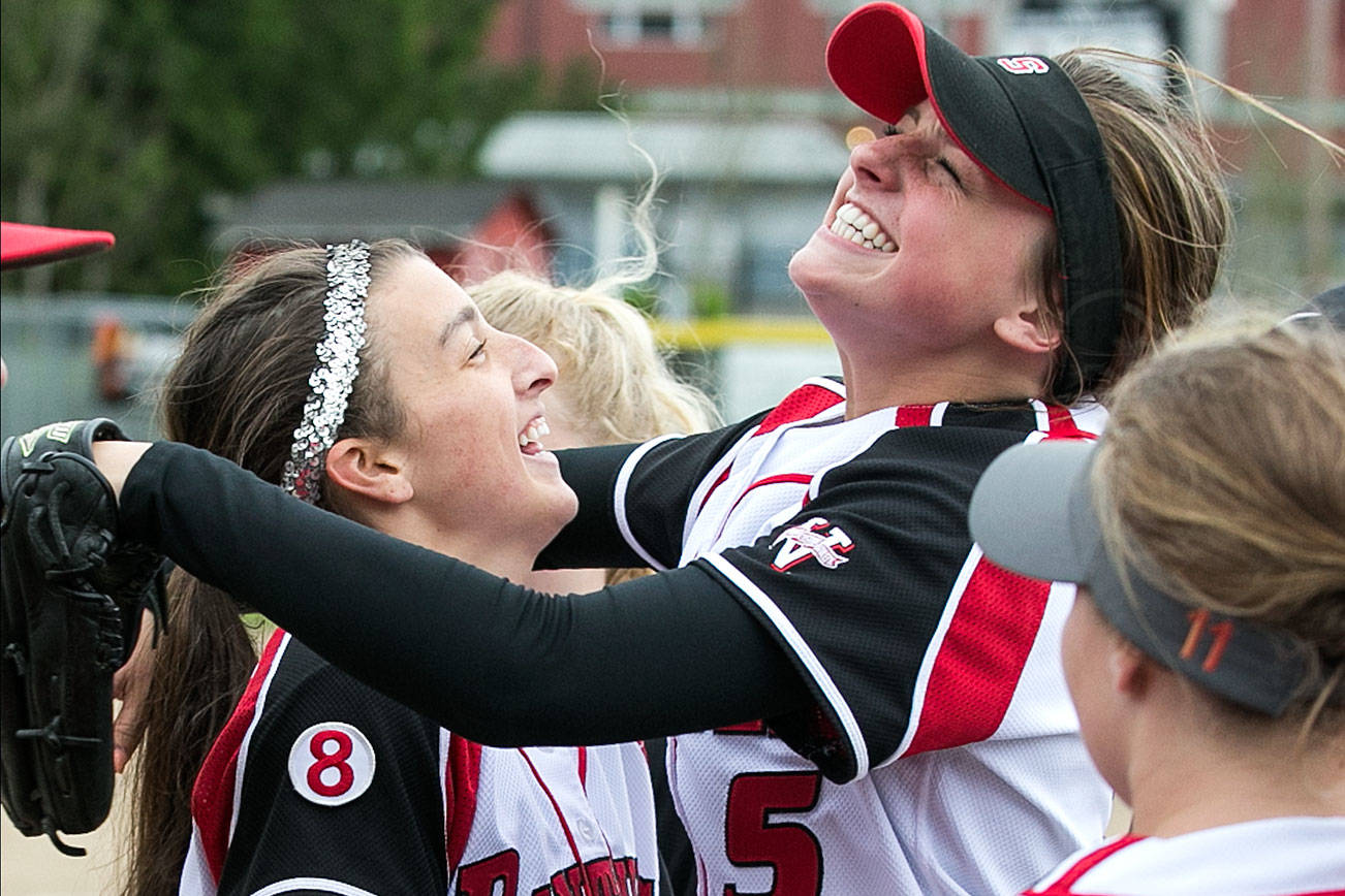 Bailey Greenlee (left) celebrates with Sami Reynolds after Greelee’s perfect game against Everett High Friday afternoon at Snohomish High School in Snohomish on April 27, 2018. (Kevin Clark / The Herald)