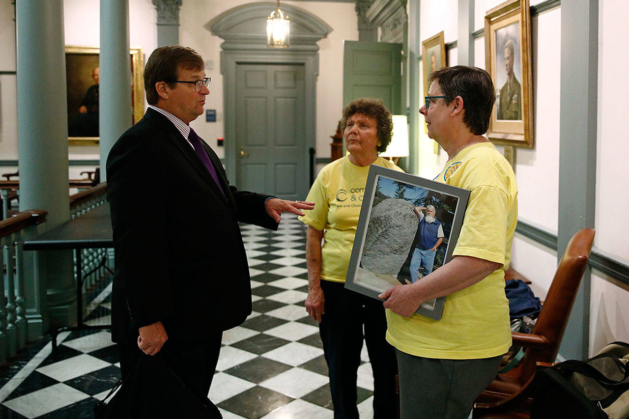 On Thursday, David Humes (left) speaks with visitors inside Legislative Hall, the state capitol building, in Dover, Del. Humes, whose son died from a heroin overdose in 2012, has been pushing for an opioid tax in Delaware, which did not increase funding for addiction treatment in 2017 as it struggles to balance its budget. (Patrick Semansky / AP Photo)