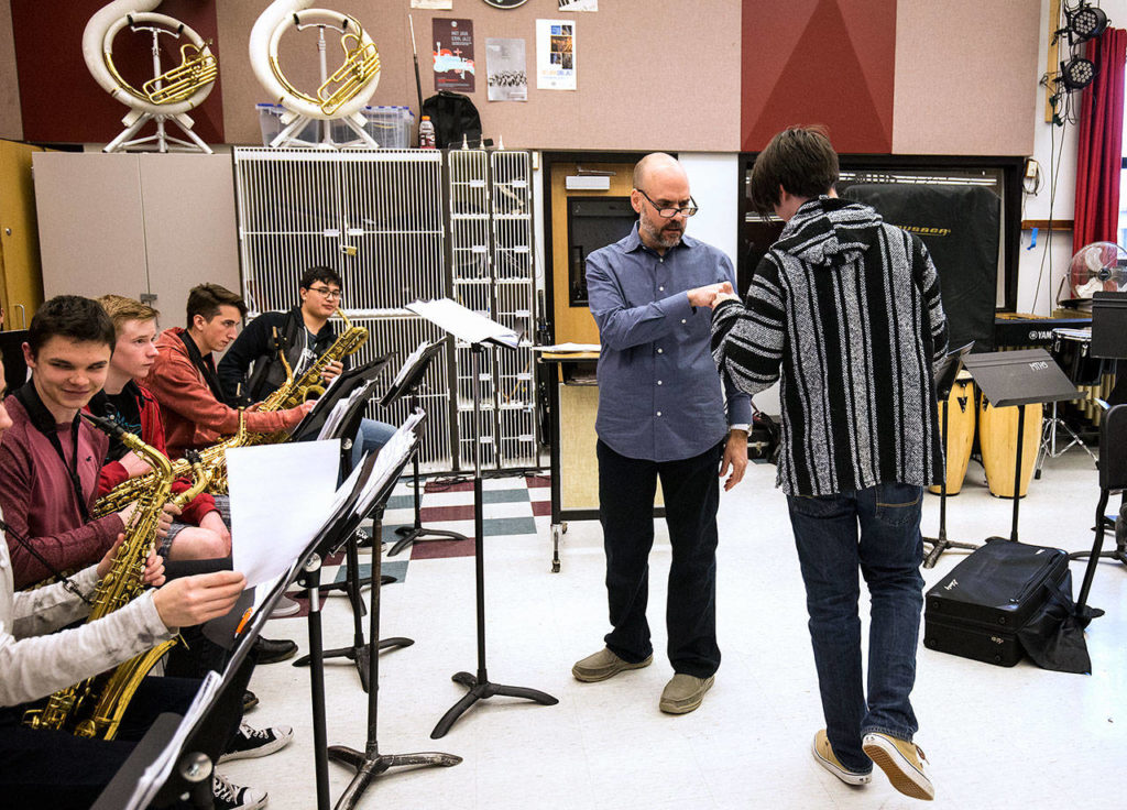 Steve Fidyk, a former Essentially Ellington judge, fists bumps Solomon Plourd after a trumpet solo as the Mountlake Terrace High School’s band rehearses during an in-school jazz workshop. (Andy Bronson / The Herald)
